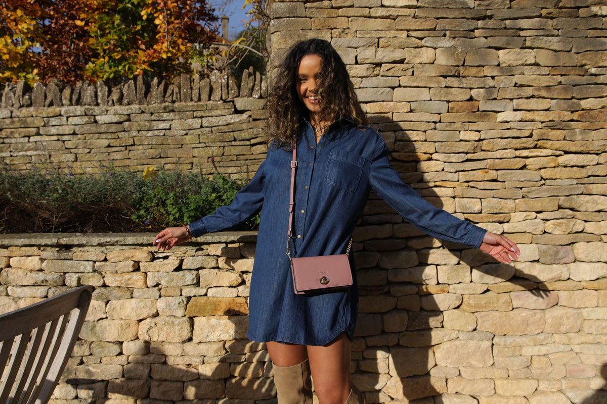 Model in denim dress in the autumnal sunshine with the Eloise Crossbody bag 
