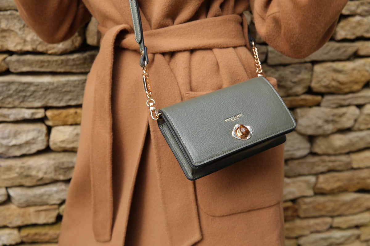 model in a camel coat wearing a Eloise crossbody chain strap Eloise 