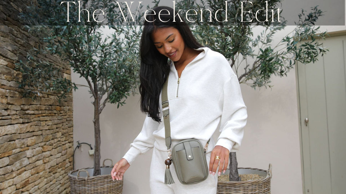 A model wearing a phone bag in sage cross body in casual tracksuit 