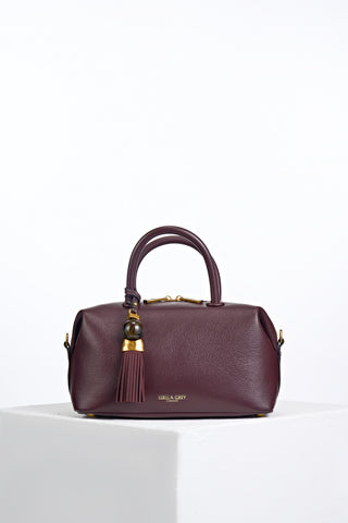 Alessia Black Cherry faux leather Bowler Tote by Luella Grey with Thames Tassel molten gold and resin detail attached to the grab handles