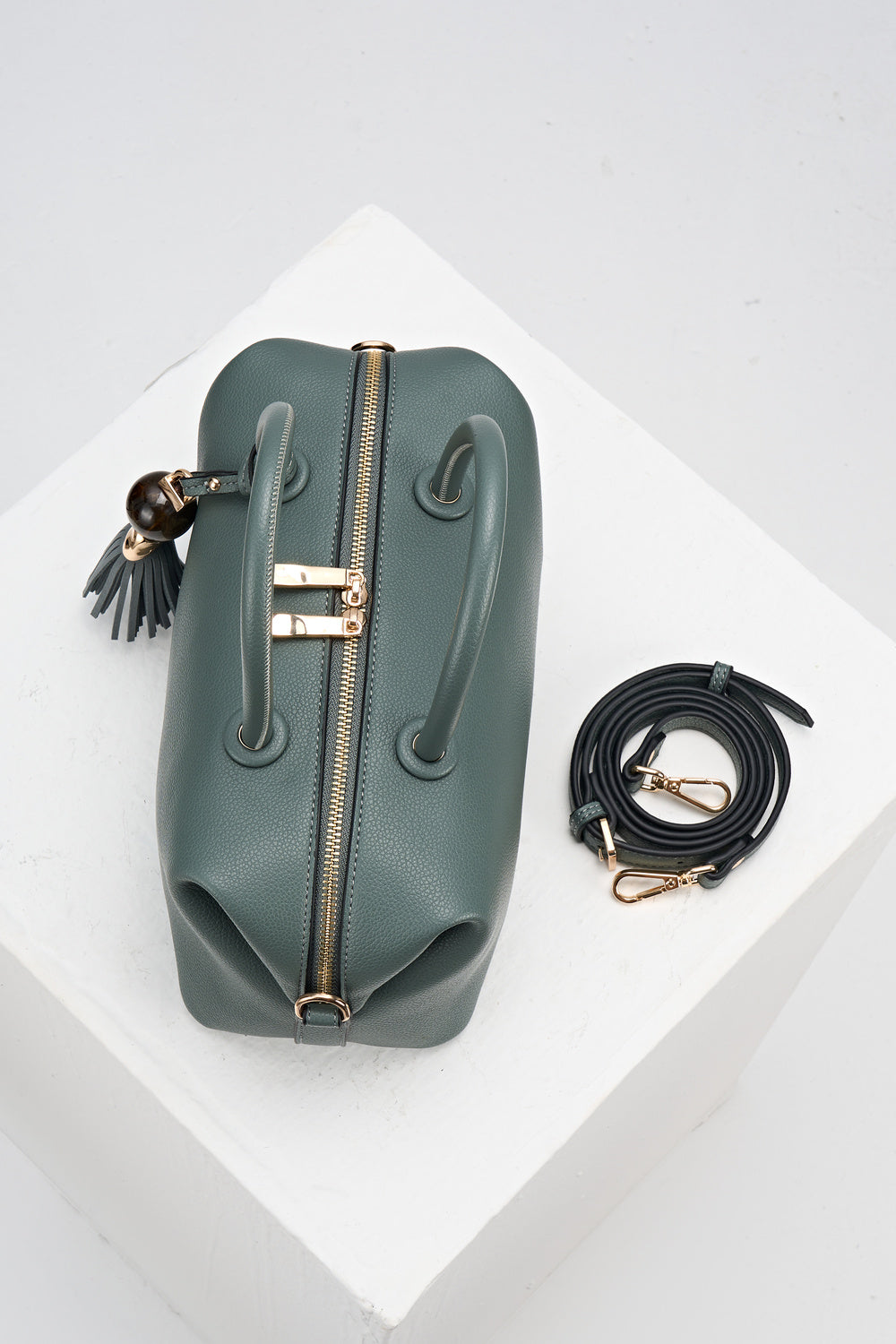 Birds-eye view of Alessia Steel Green leather Bowler Tote by Luella Grey with matching detachable crossbody strap rolled up next to the bag