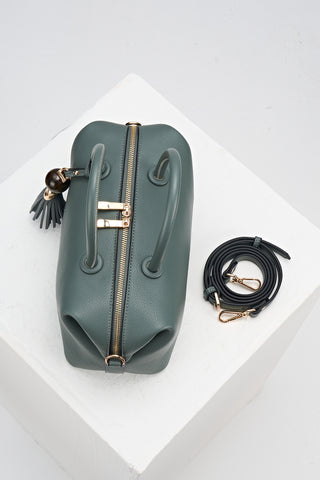 Birds-eye view of Alessia Steel Green leather Bowler Tote by Luella Grey with matching detachable crossbody strap rolled up next to the bag
