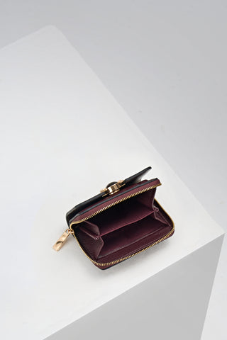 Inside of Erin Black Cherry Small Faux Leather Purse by Luella Grey which is unzipped showing the coin slots inside