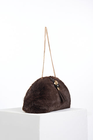 Side view of Indigo Chocolate faux fur Oversized Clutch showing the gold clasp closure and detachable gold metal chain shoulder strap