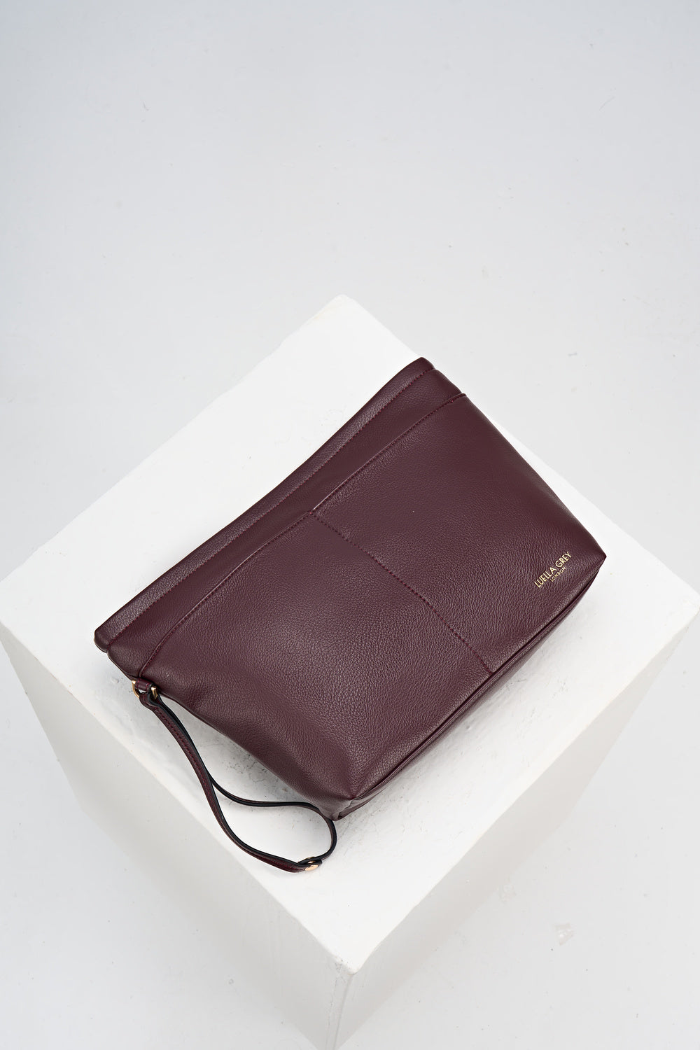 Overhead view of the internal detachable sipper pouch from Saskia Black Cherry faux leather Woven Tote