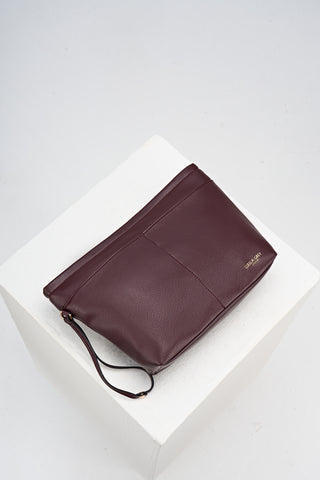 Overhead view of the internal detachable sipper pouch from Saskia Black Cherry faux leather Woven Tote