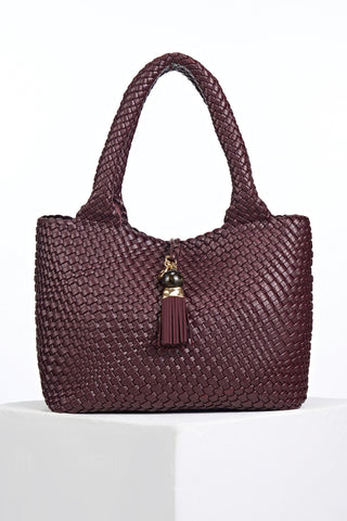 Front view of Saskia Black Cherry faux leather Woven Tote with Thames Tassel closure detail