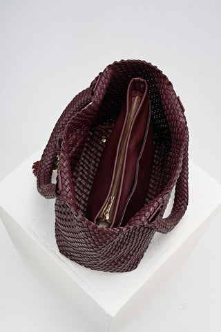 Overhead view of the inside of Saskia Black Cherry faux leather Woven Tote with internal detachable zipper pouch