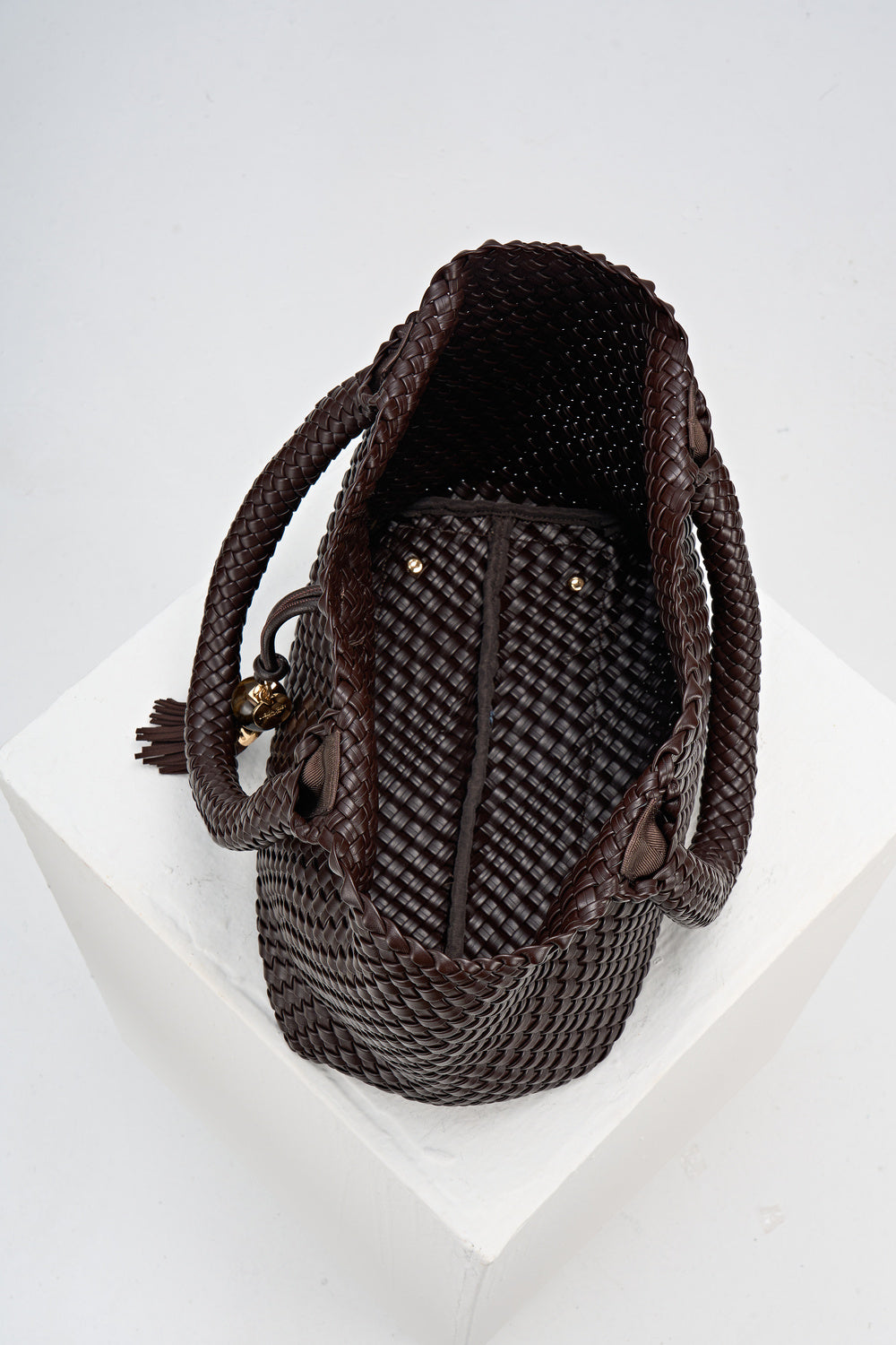 Overhead view of the inside of Saskia Chocolate faux leather Woven Tote 