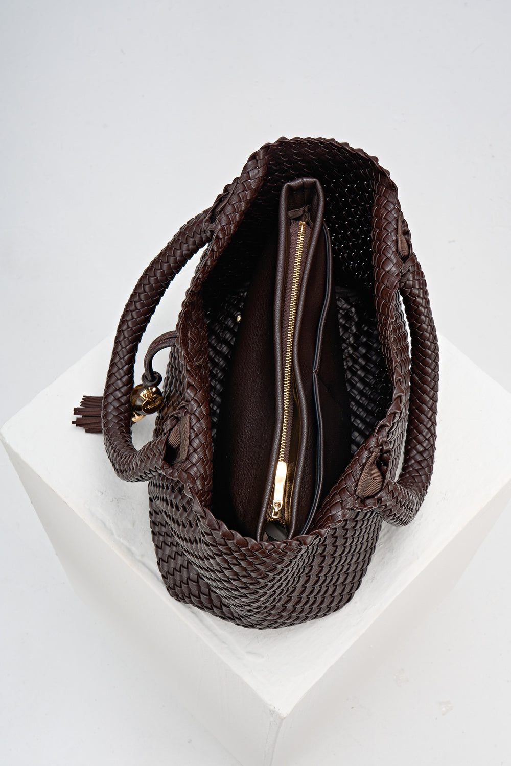 Overhead view of the inside of Saskia Chocolate faux leather Woven Tote with internal detachable zipper pouch