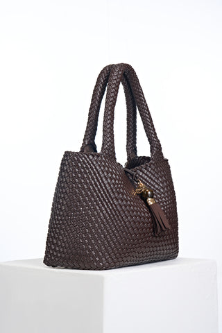Side view of Saskia Chocolate faux leather Woven Tote with Thames Tassel closure detail