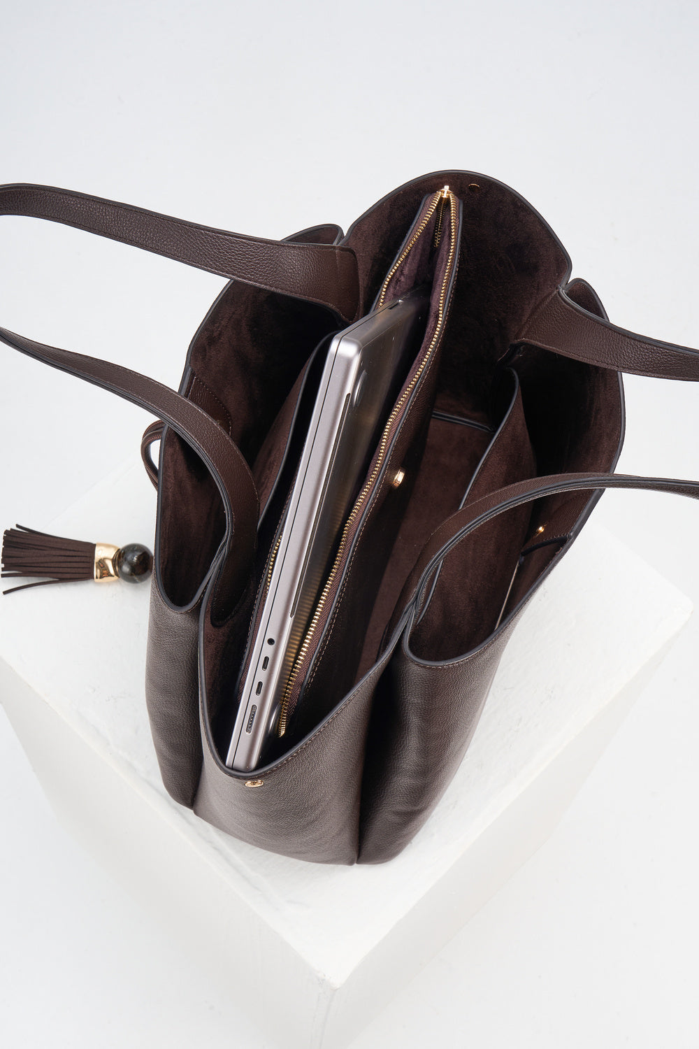 Overhead view of the inside of Stella Chocolate faux leather Laptop Tote showing internal compartments and detachable central zipper laptop compartment