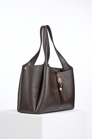 Side view of Stella Chocolate faux leather Laptop Tote with Mayfair Tassel Closure detail