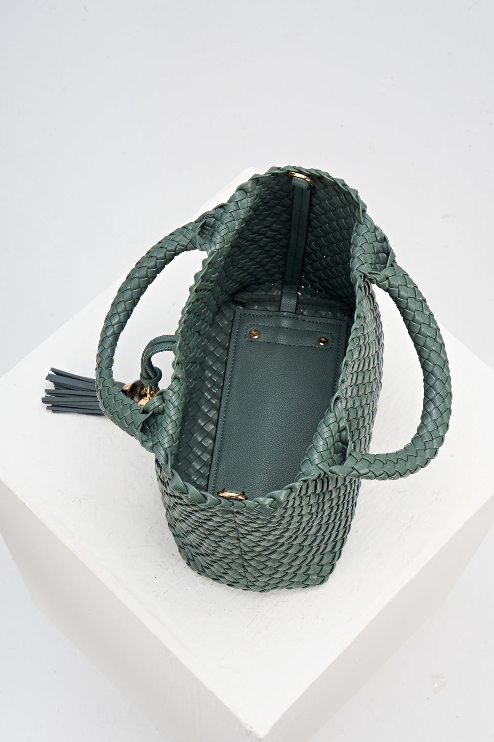 Overhead view of Suky Steel Green faux leather Woven Crossbody 