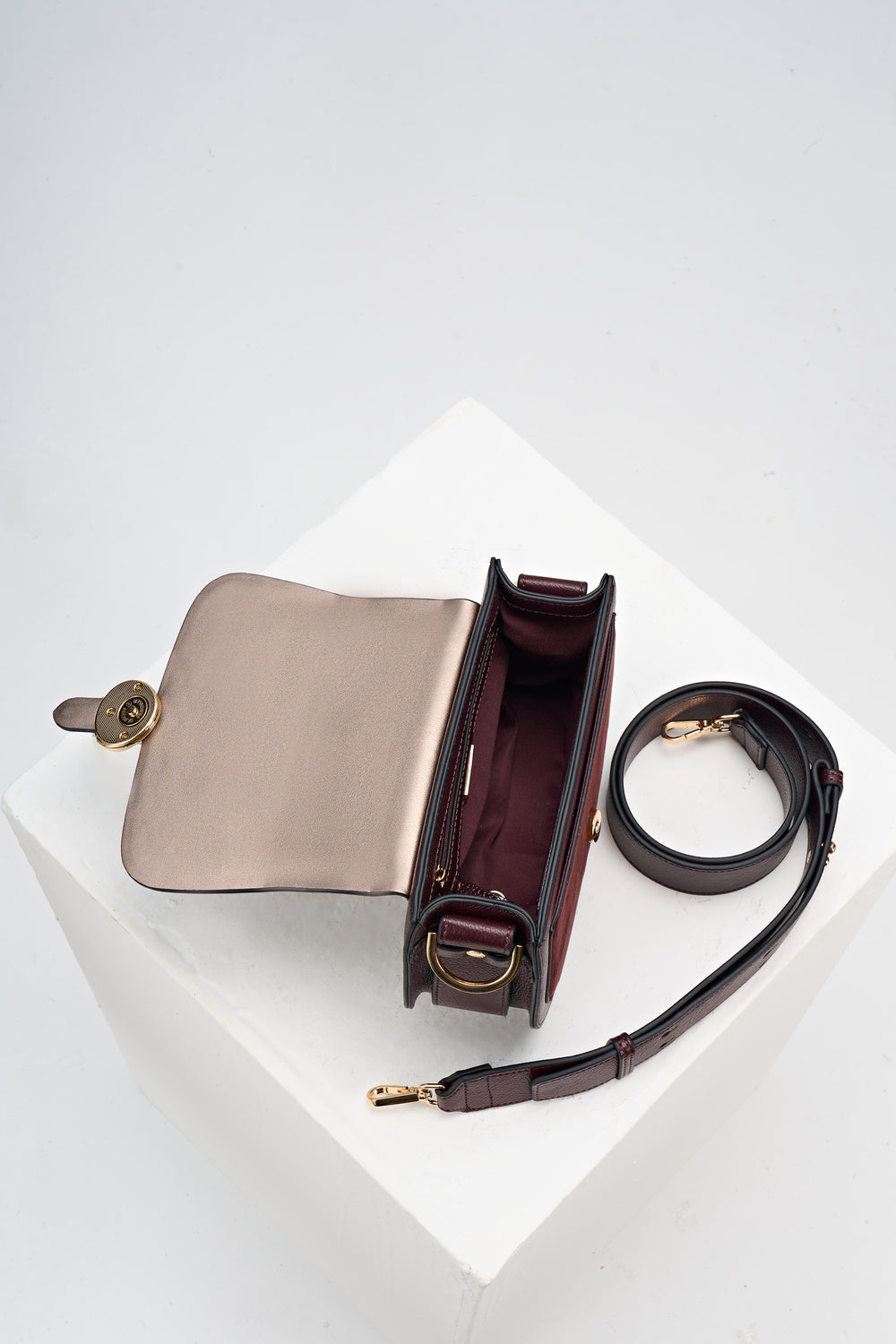 Overhead shot of the inside of Venetia Black Cherry Faux leather Saddle Crossbody with detached crossbody strap