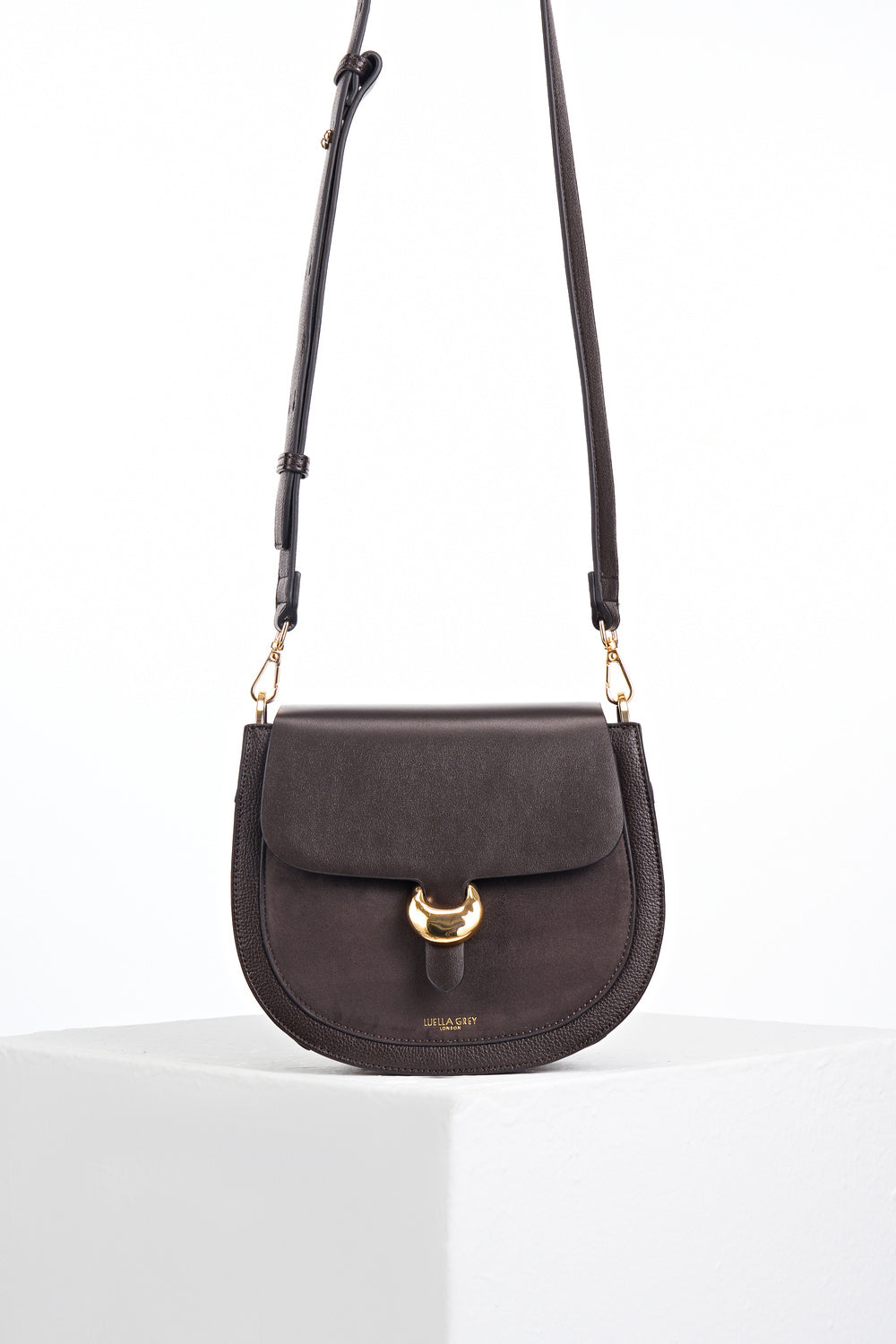 Venetia Chocolate Faux leather Saddle Crossbody with gold Cannon Street Clasp Closure detail on the front flap